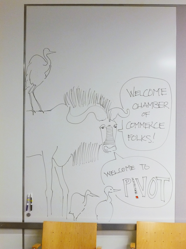 Life-sized drawing of a wildebeest with a bird on it's back.  Dry-erase marker on white board, 2012.
