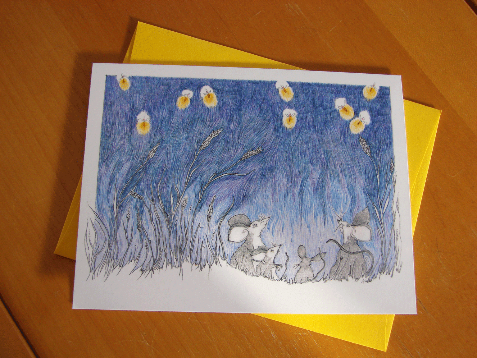 Photo of a card featuring fieldmice watching a display of fireflies.